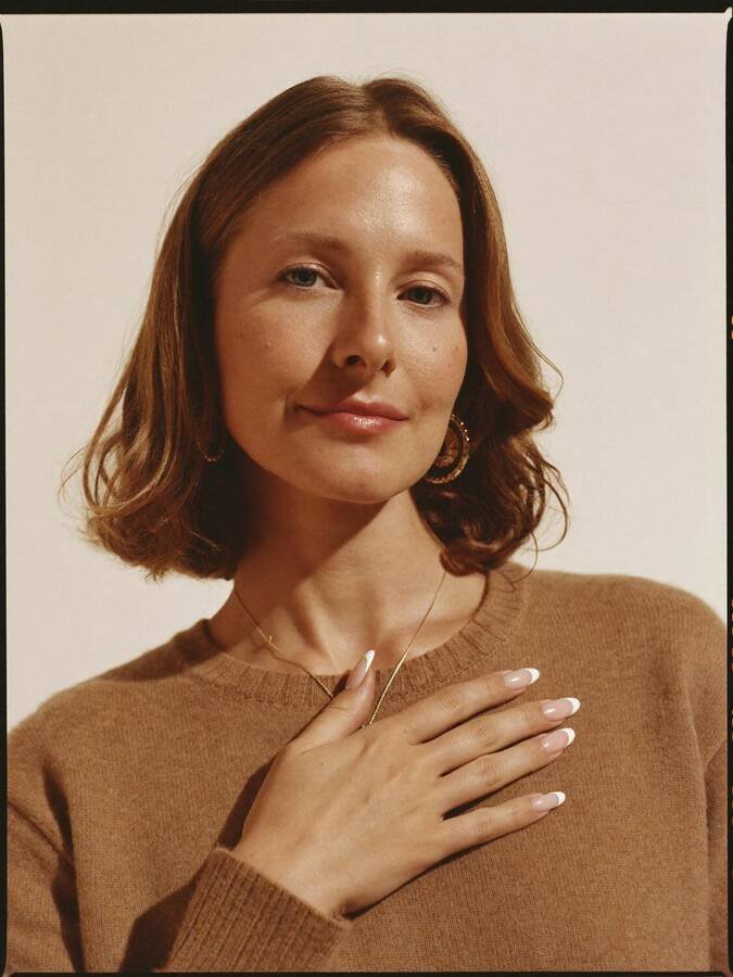 Portrait of a guest with a soft pink French manicure